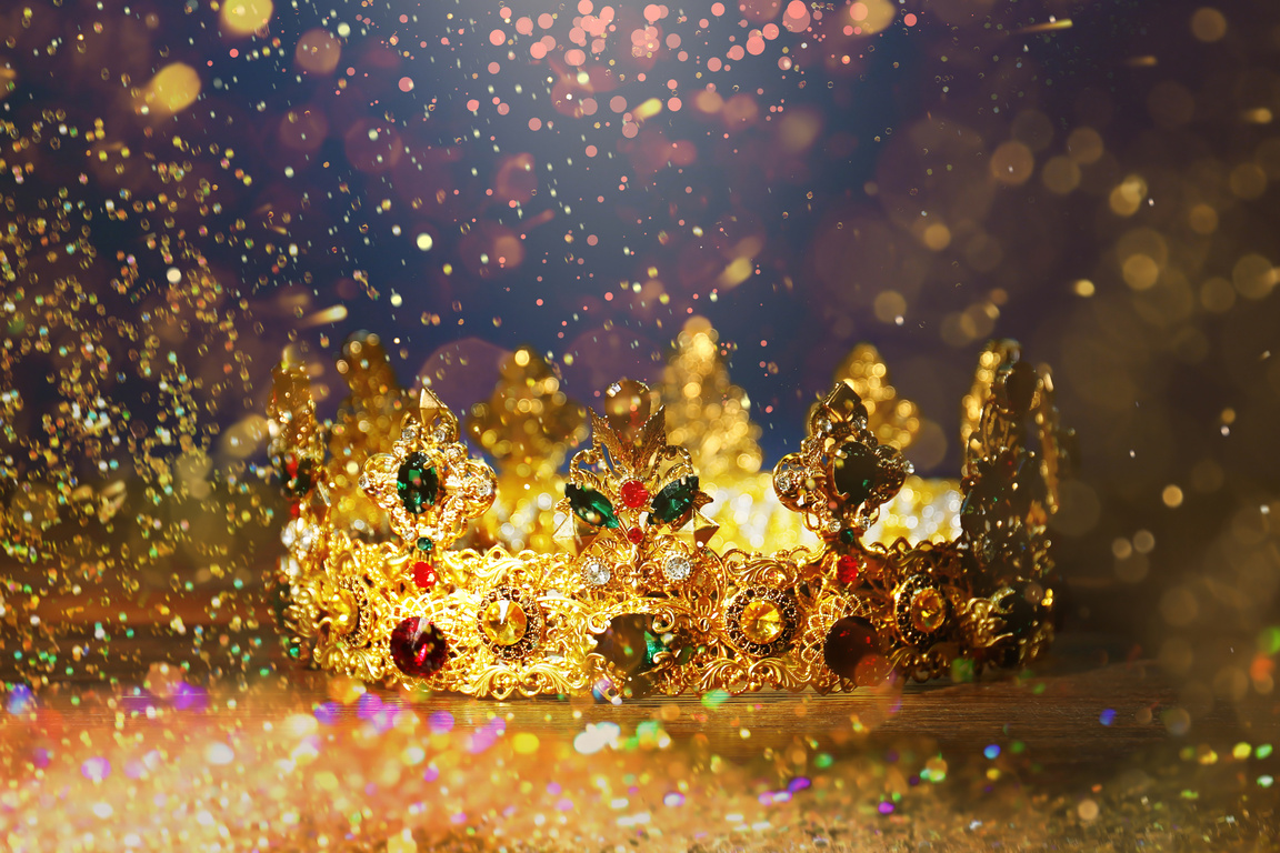 Fantasy World. Beautiful Golden Crown Lit by Magic Light on Table, Bokeh Effect